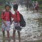Foto: Murid sekolah dasar melintasi banjir yang merendam kawasan Taman Narogong, Rawalumbu, Bekasi, Jawa Barat, Kamis (22/1/2026). (Dok-Antara)