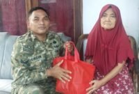 Foto: Sertu Nurdin menyerahkan bantuan sembako kepada seorang warga lanjut usia di Desa Dagangan, Kecamatan Dagangan, Kabupaten Madiun, Minggu (31/5/2026)
