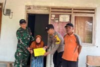 Foto: Babinsa Sumberingin Serka Aman Yuono bersama Bhabinkamtibmas Brigadir Polisi Wahyu Aji mendampingi penyaluran Bantuan Langsung Tunai (BLT) secara door to door kepada warga Desa Sumberingin, Kecamatan Karangan, Kabupaten Trenggalek, Selasa (29/9/2026).